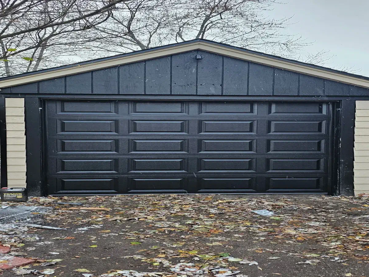 Dark brown raised panel double garage door on a detached garage in Milwaukee