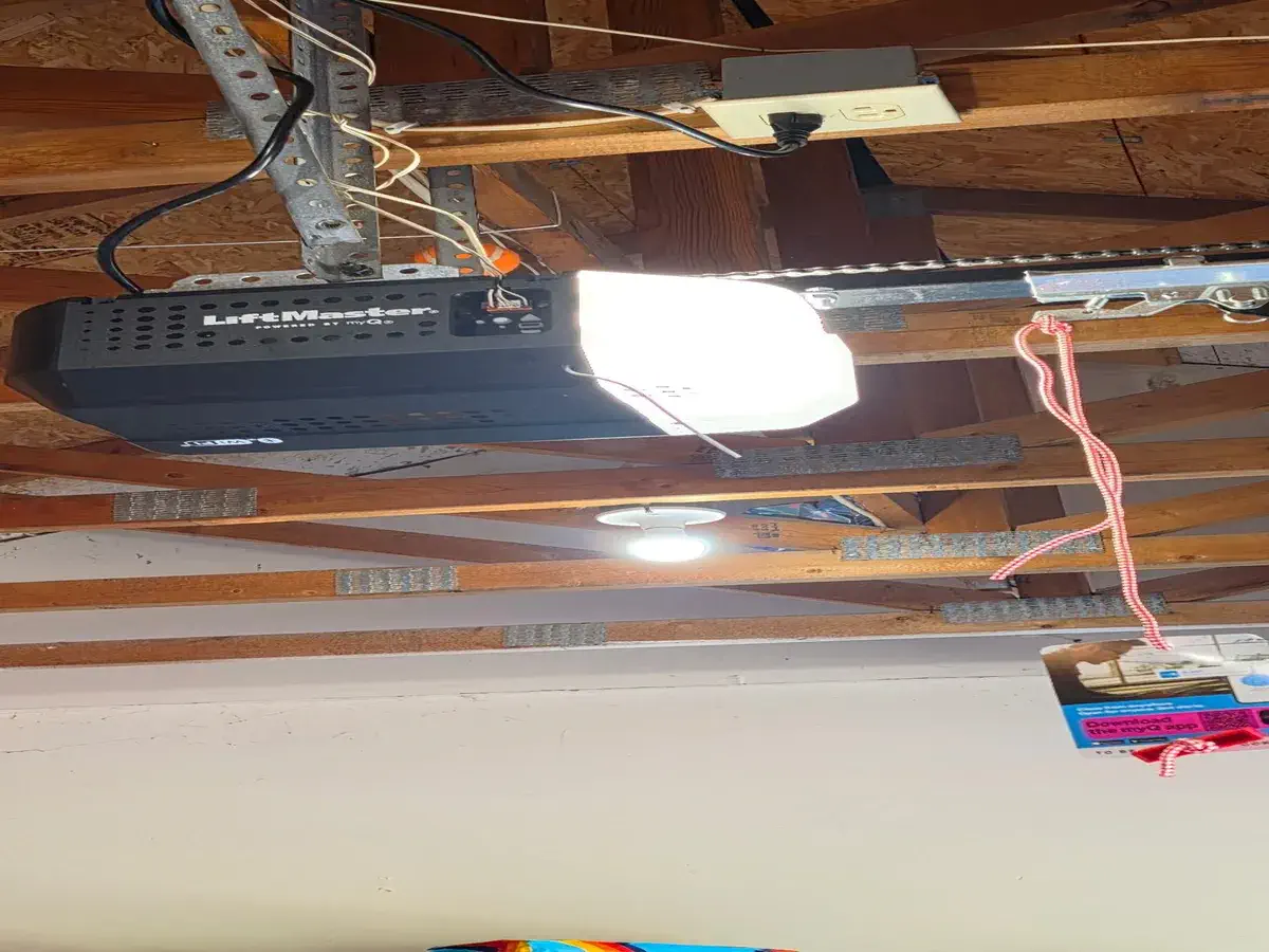 LiftMaster garage door opener installed on the ceiling rail inside a garage